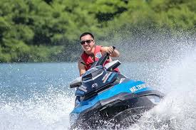 Book Jet Skis FREE Now * Don't Pay 'til You Play * Happy Man Riding a Jet Ski on the Lake * Bass Lake Boat Rentals